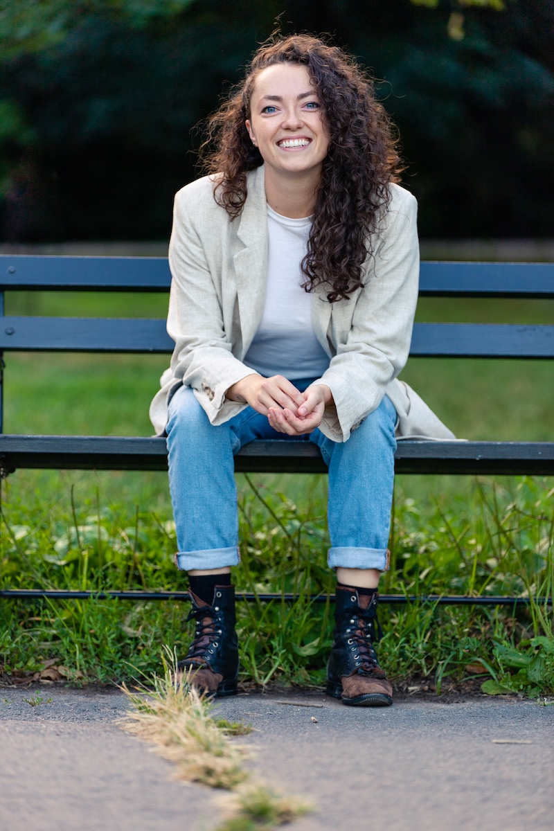 Kailey sitting on a bench outdoors